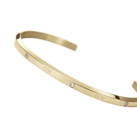 Adjustable gold stainless steel Daniel Wellington Classic Lumine cuff bangle featuring six sparkling crystals.