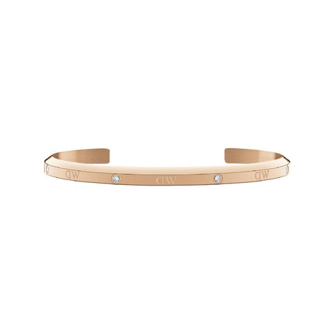Adjustable rose gold stainless steel cuff bracelet featuring six sparkling crystals and elegant Daniel Wellington branding.