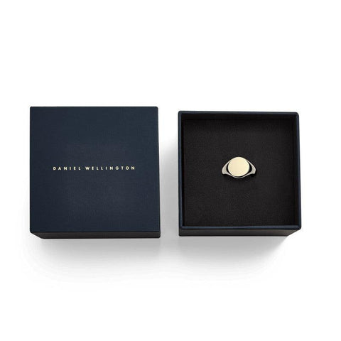 Daniel Wellington Classic Signet Ring in gold-plated stainless steel, displayed in a branded navy gift box.