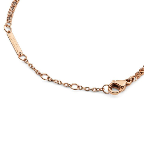 Daniel Wellington rose gold tennis bracelet with apricot crystals, adjustable stainless steel chain, and lobster clasp.