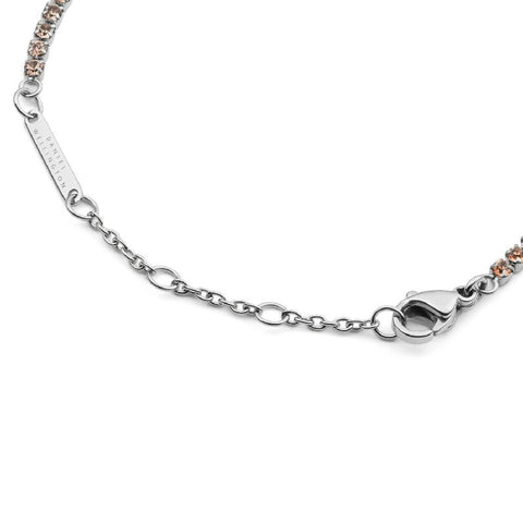 Daniel Wellington silver tennis bracelet with apricot crystals, stainless steel chain, and adjustable lobster clasp.
