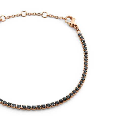 Daniel Wellington rose gold tennis bracelet featuring shimmering dark crystals and an adjustable stainless steel chain.