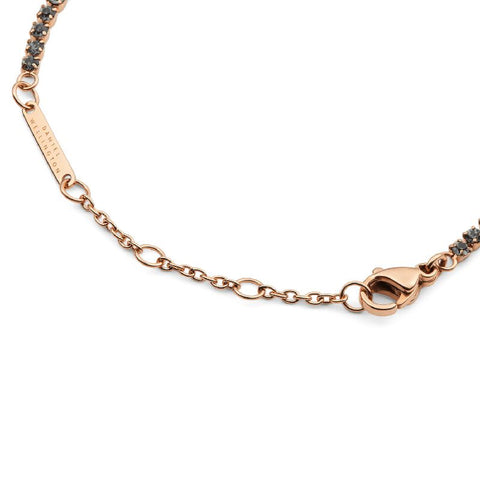Rose gold Daniel Wellington tennis bracelet with dark crystals, lobster clasp, and adjustable sizing rings.