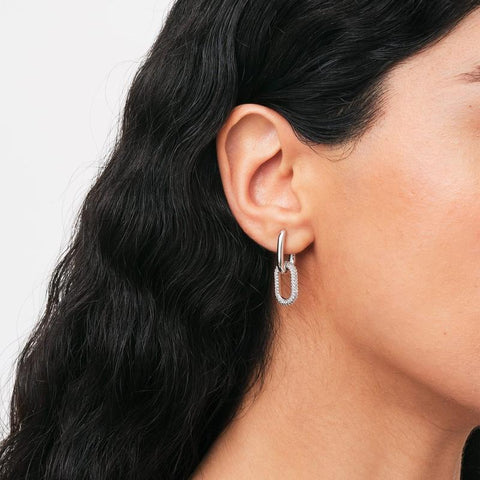 Daniel Wellington silver Crystal Link earrings featuring a chunky chain design with sparkling claw-set crystals on a model.
