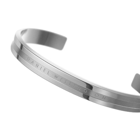 Elegant silver Daniel Wellington Elan cuff bracelet crafted from polished stainless steel with engraved logo detailing.