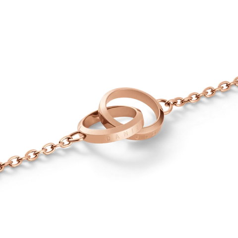 Elegant rose gold Daniel Wellington Elan Unity bracelet featuring two interlocking rings on a delicate stainless steel chain.