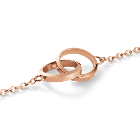 Elegant rose gold Daniel Wellington Elan Unity necklace featuring two interlocking rings on a delicate chain.