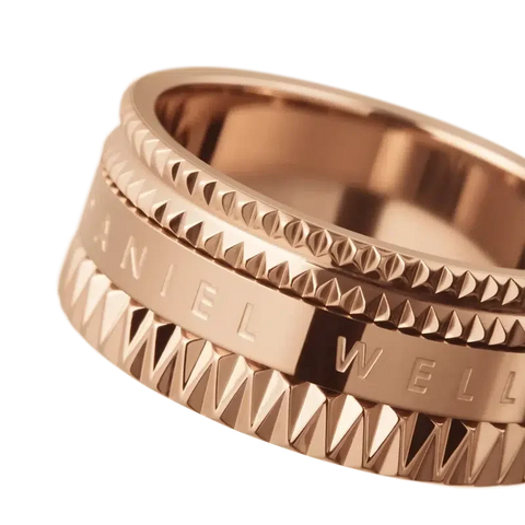Daniel Wellington Elevation ring in rose gold-plated stainless steel with a geometric, textured design and engraved logo.