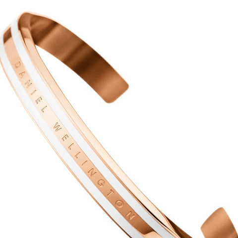 Elegant rose gold Daniel Wellington Emalie slim cuff bracelet with a white enamel inlay and engraved logo detail.