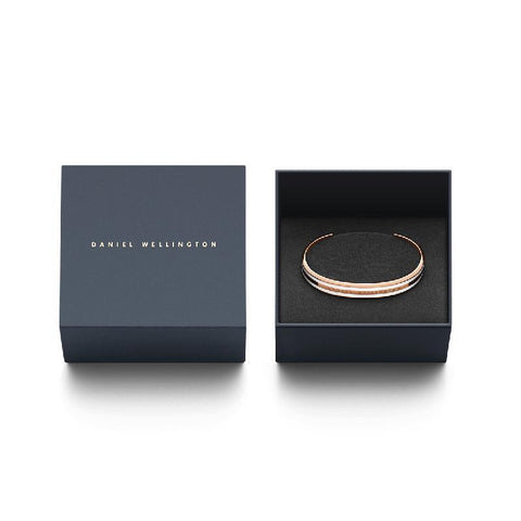 Elegant rose gold and enamel Daniel Wellington Emalie Slim cuff bangle presented in a signature branded gift box.