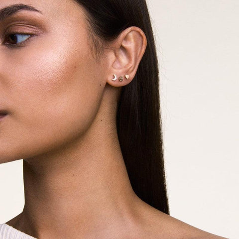 Elegant Daniel Wellington heart stud earring in polished silver stainless steel, 3.8mm size, worn on a model's ear.