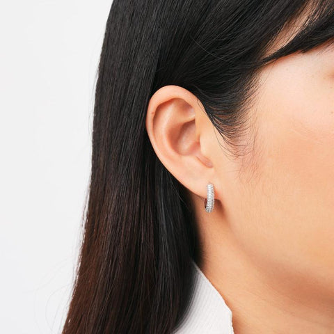 Daniel Wellington silver rhodium-plated brass hoop earrings featuring a sparkling pavé crystal claw setting.