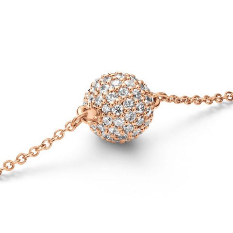 Daniel Wellington rose gold pendant bracelet featuring a sparkling, crystal-encrusted pavé sphere on a delicate chain.