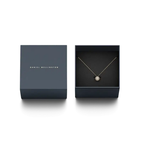 Daniel Wellington gold pavé crystal pendant necklace displayed in a premium branded gift box.