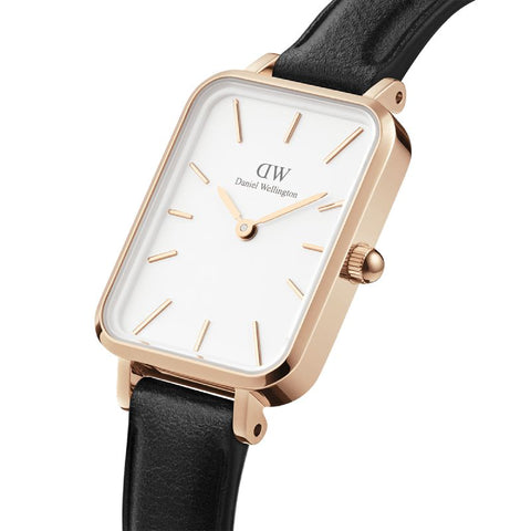 Daniel Wellington Quadro watch with a rose gold square case, eggshell white dial, and black leather strap.