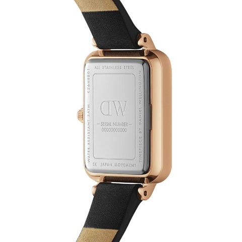 Rose gold stainless steel case back of the Daniel Wellington Quadro watch with a black leather strap.