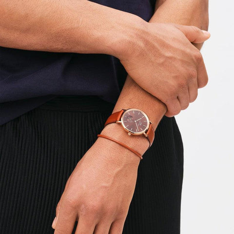 Daniel Wellington St Mawes brown leather bracelet with rose gold clasp worn alongside a matching leather watch.
