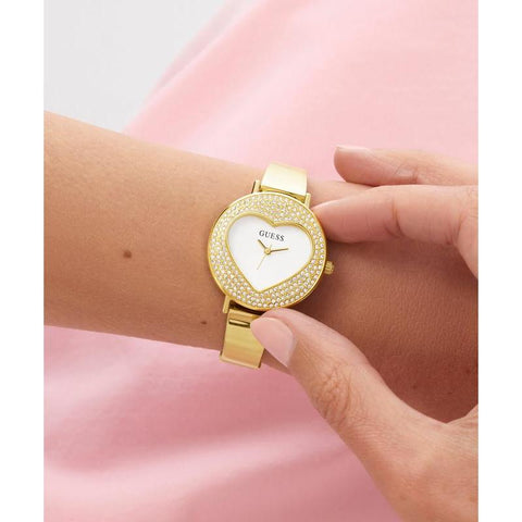 The Watch Boutique Guess Ladies Gold Tone Analog Watch with Heart‑Shaped Sunray Dial